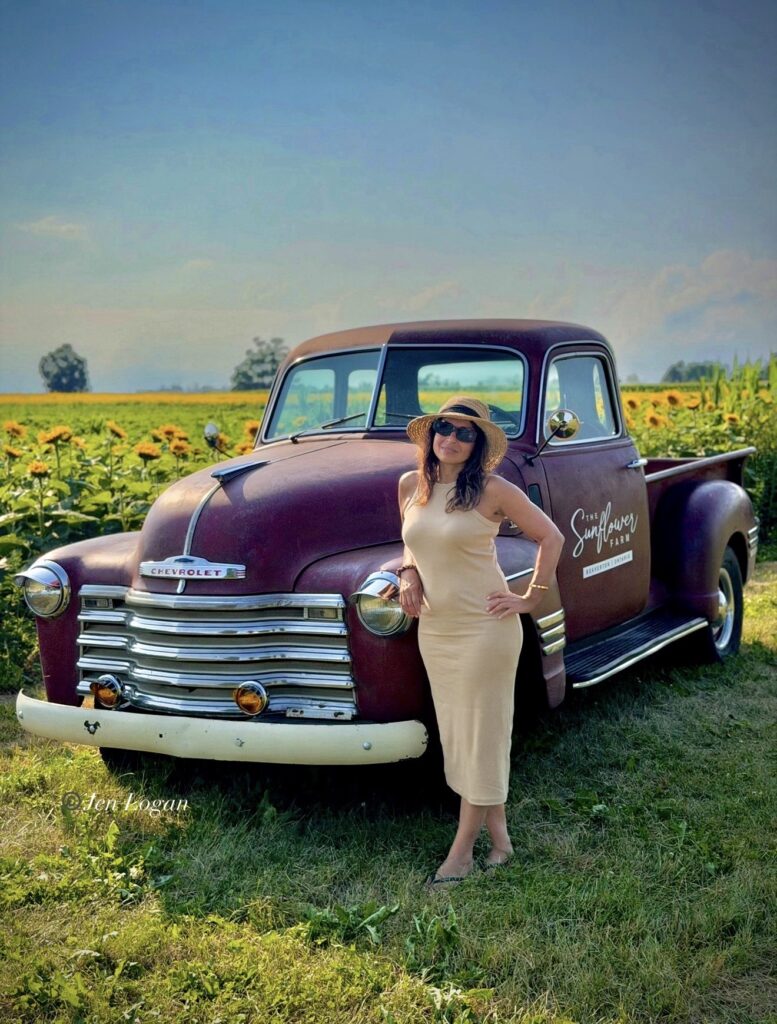 There are tons of photo ops like this one where a woman poses in front of an old redone 1920's era pickup truck with a sunflower field behind her at the Sunflower Farm in Beaverton